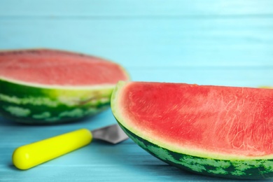 Photo of Yummy cut watermelon on light blue wooden table