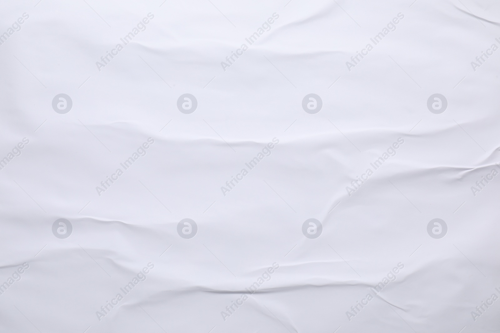 Photo of White crumpled sheet of paper as background, top view. Wall poster