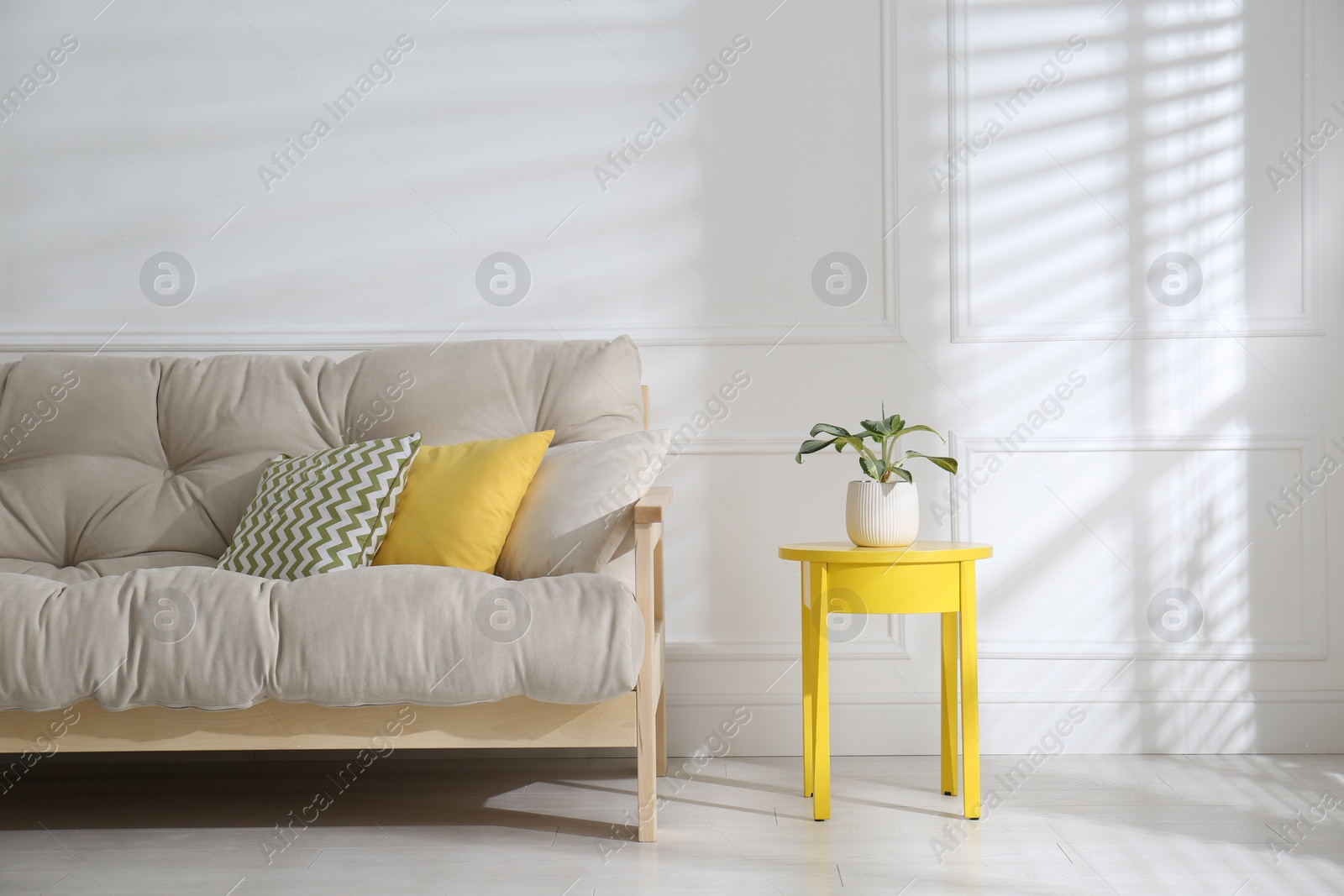 Photo of Stylish beige sofa in living room interior