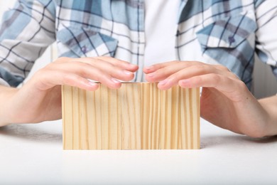 Photo of Woman demonstrating empty blocks at white table, closeup. Space for design