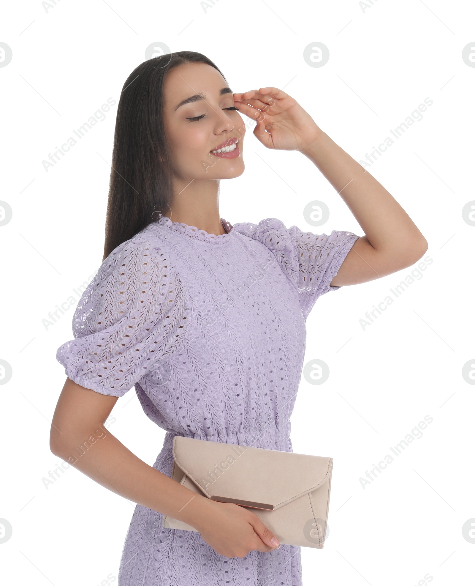 Photo of Young woman wearing stylish lilac dress with elegant clutch on white background