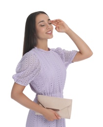 Photo of Young woman wearing stylish lilac dress with elegant clutch on white background