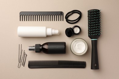 Photo of Flat lay composition with brush, combs and different hair products on light grey background