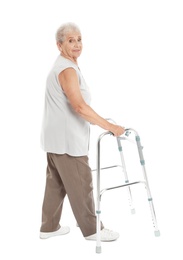 Full length portrait of elderly woman using walking frame isolated on white