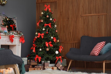 Photo of Stylish living room interior with decorated Christmas tree