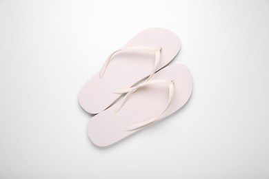 Stylish flip flops on white background, top view