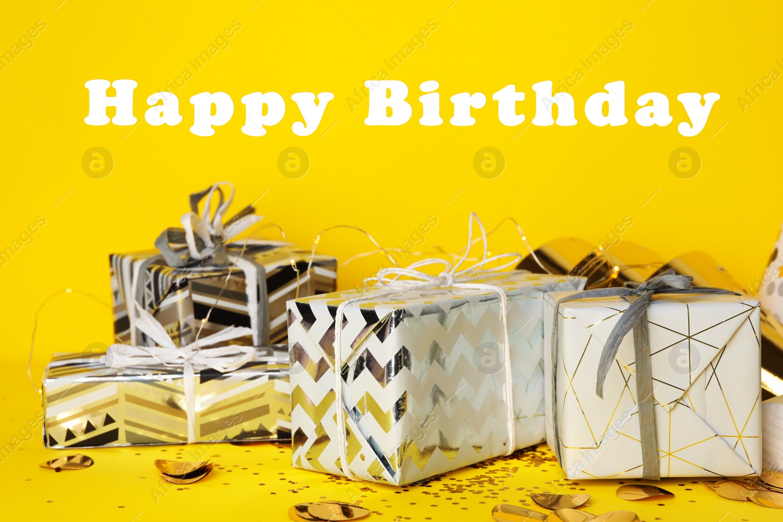 Photo of Gift boxes and text Happy Birthday on yellow background