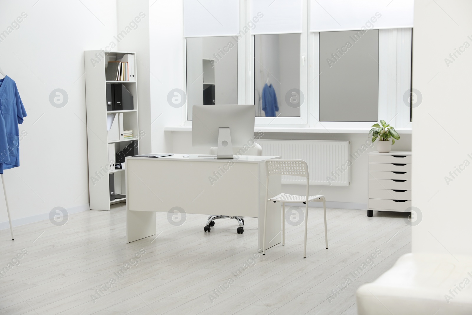 Photo of Stylish medical office interior with doctor's workplace