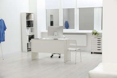 Photo of Stylish medical office interior with doctor's workplace