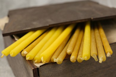 Wooden box with church candles, closeup view