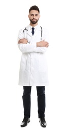 Photo of Young male doctor in uniform isolated on white