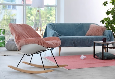 Photo of Elegant living room interior with rocking chair and cozy sofa