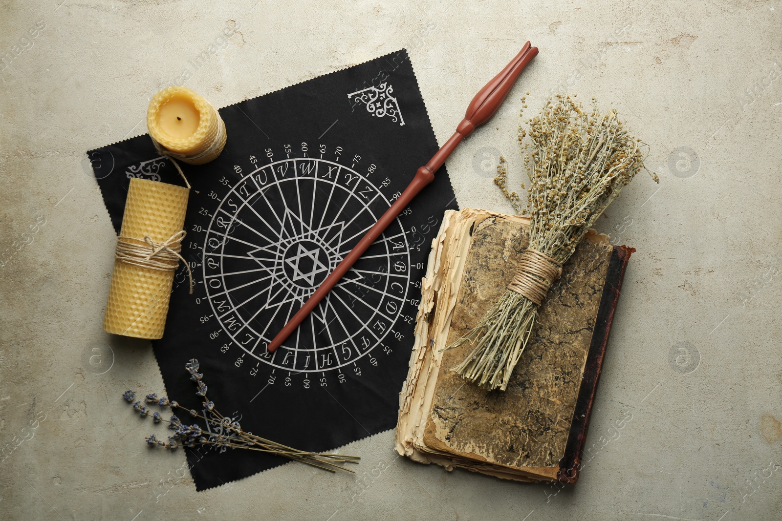 Photo of Flat lay composition with magic wand and divination cloth on light textured background