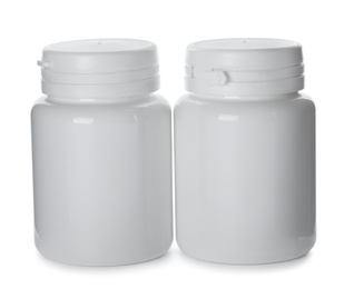 Photo of Plastic bottles for pills on white background