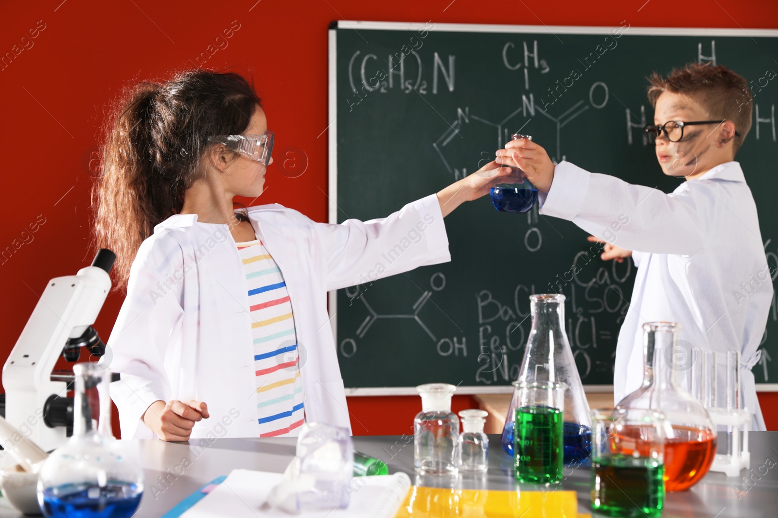 Photo of Children doing chemical research in laboratory. Dangerous experiment