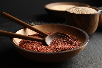 Plate with spoons and red quinoa on black table