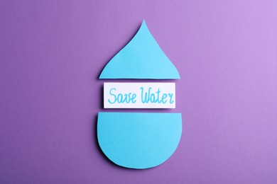 Photo of Words Save Water between parts of paper drop on purple background, flat lay