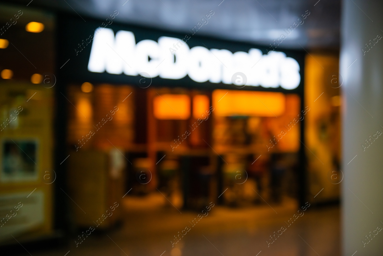 Photo of WARSAW, POLAND - AUGUST 05, 2022: Blurred view of McDonald's Restaurant entrance indoors