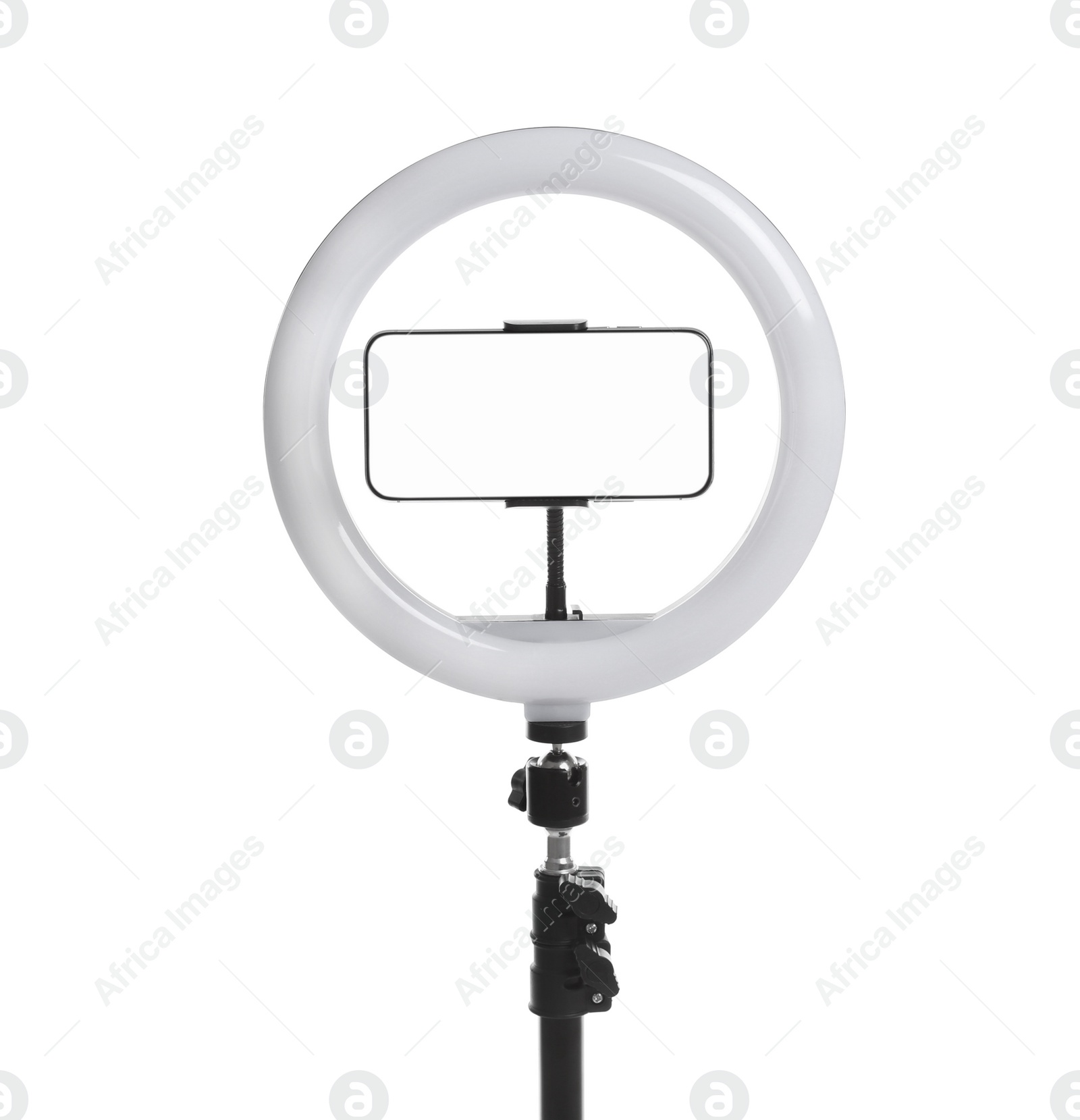 Photo of Modern tripod with ring light and smartphone isolated on white