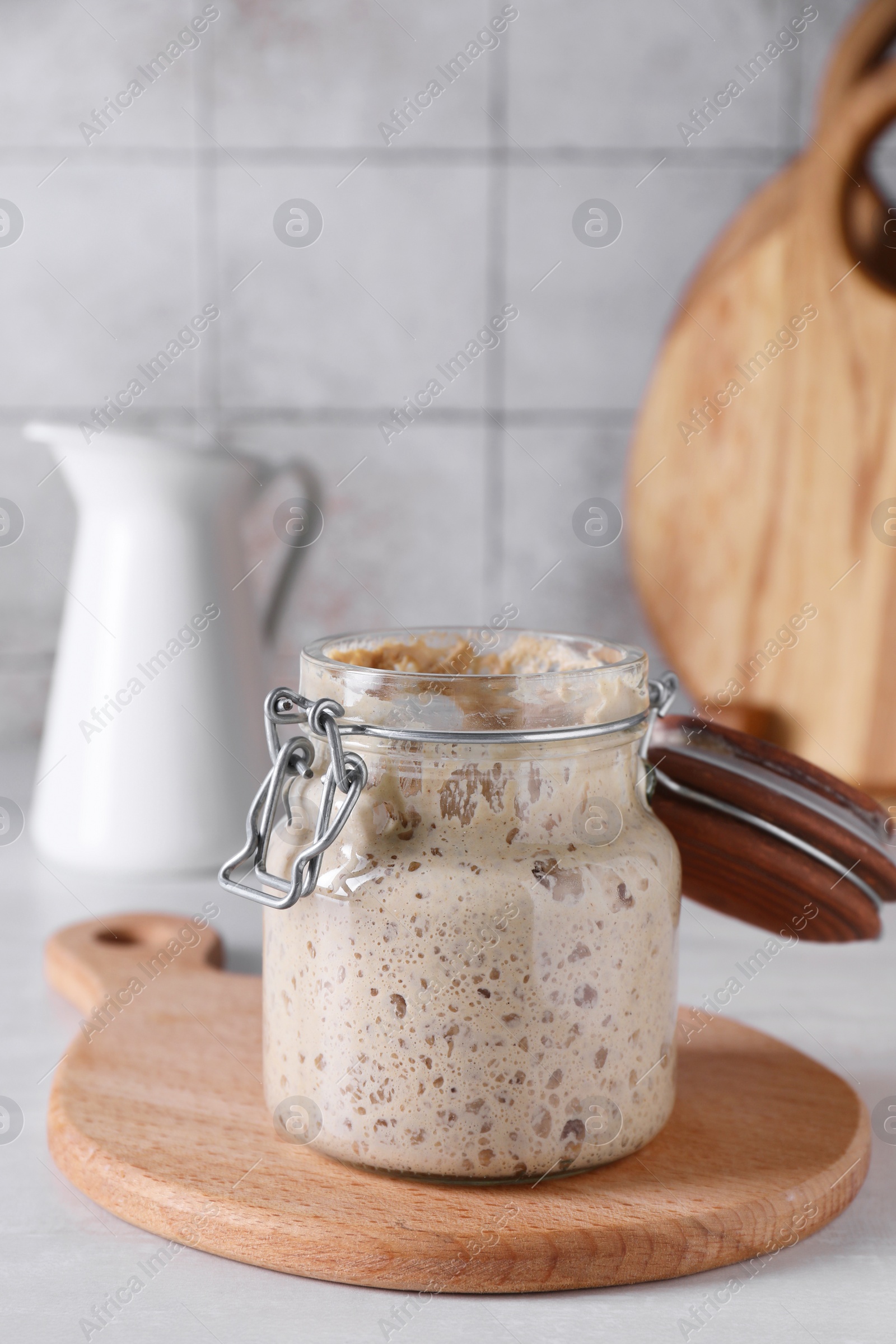 Photo of Sourdough starter in glass jar on light table