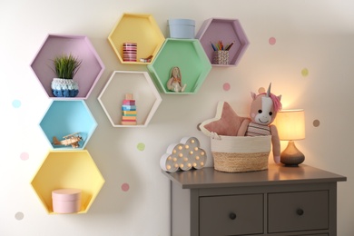 Bright colorful shelves on light wall in room. Interior design