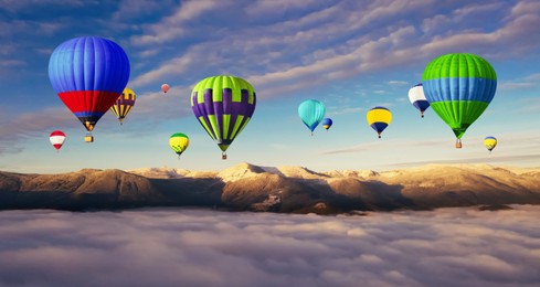 Image of Hot air balloons flying over foggy mountains. Banner design