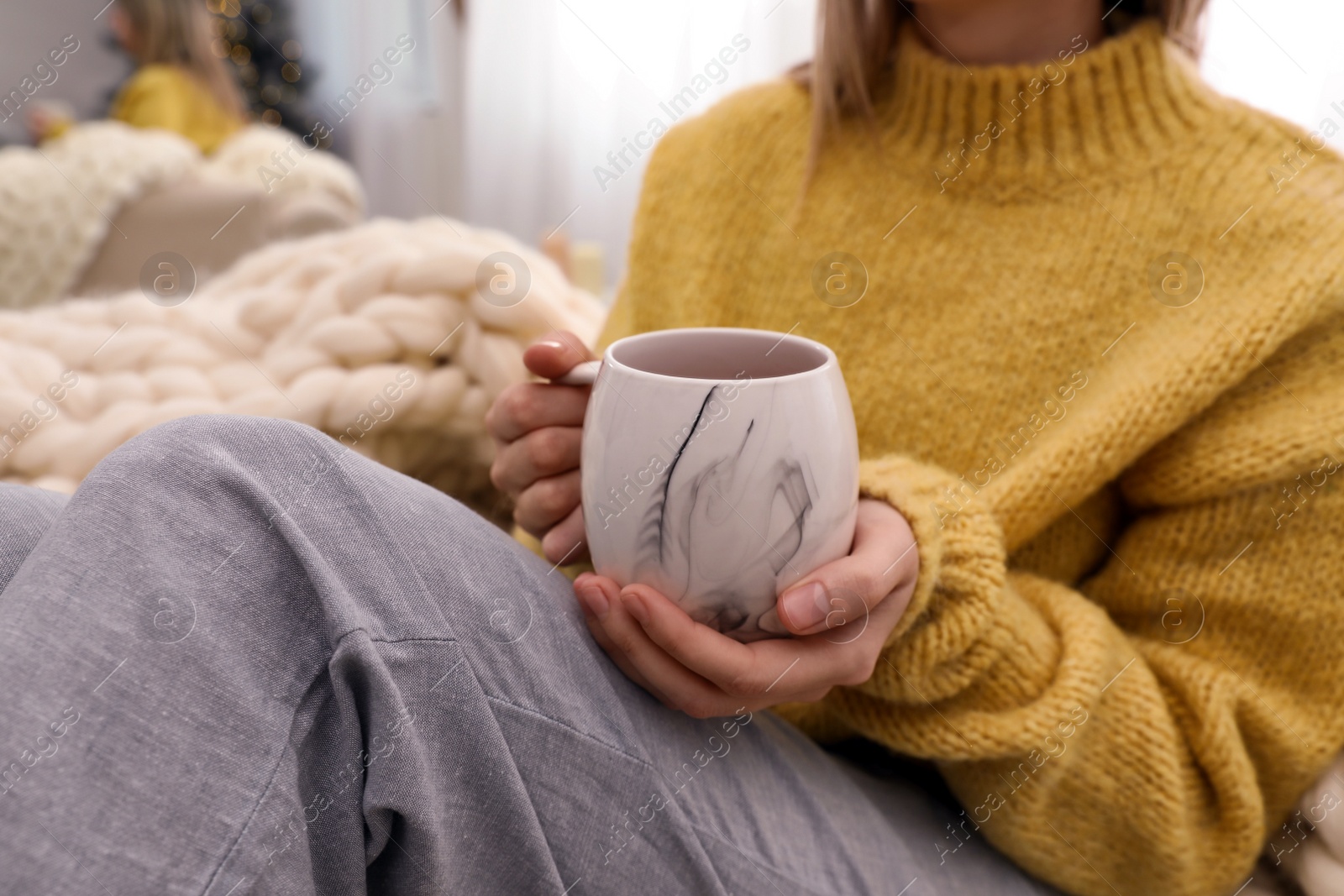 Photo of Woman with cup of drink indoors, closeup