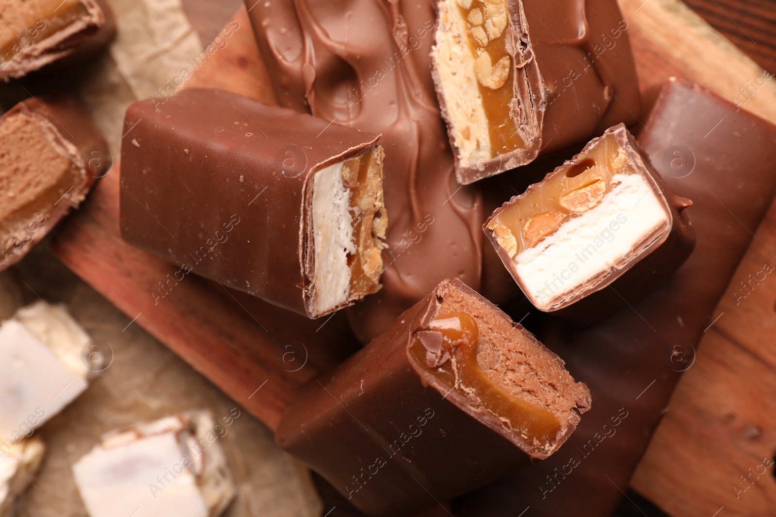 Photo of Tasty chocolate bars and nougat on table, top view