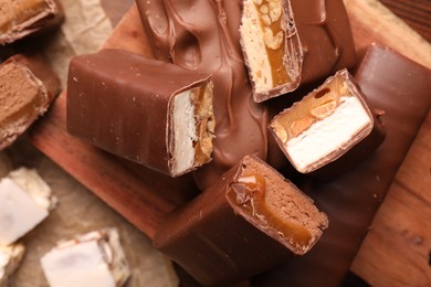 Tasty chocolate bars and nougat on table, top view