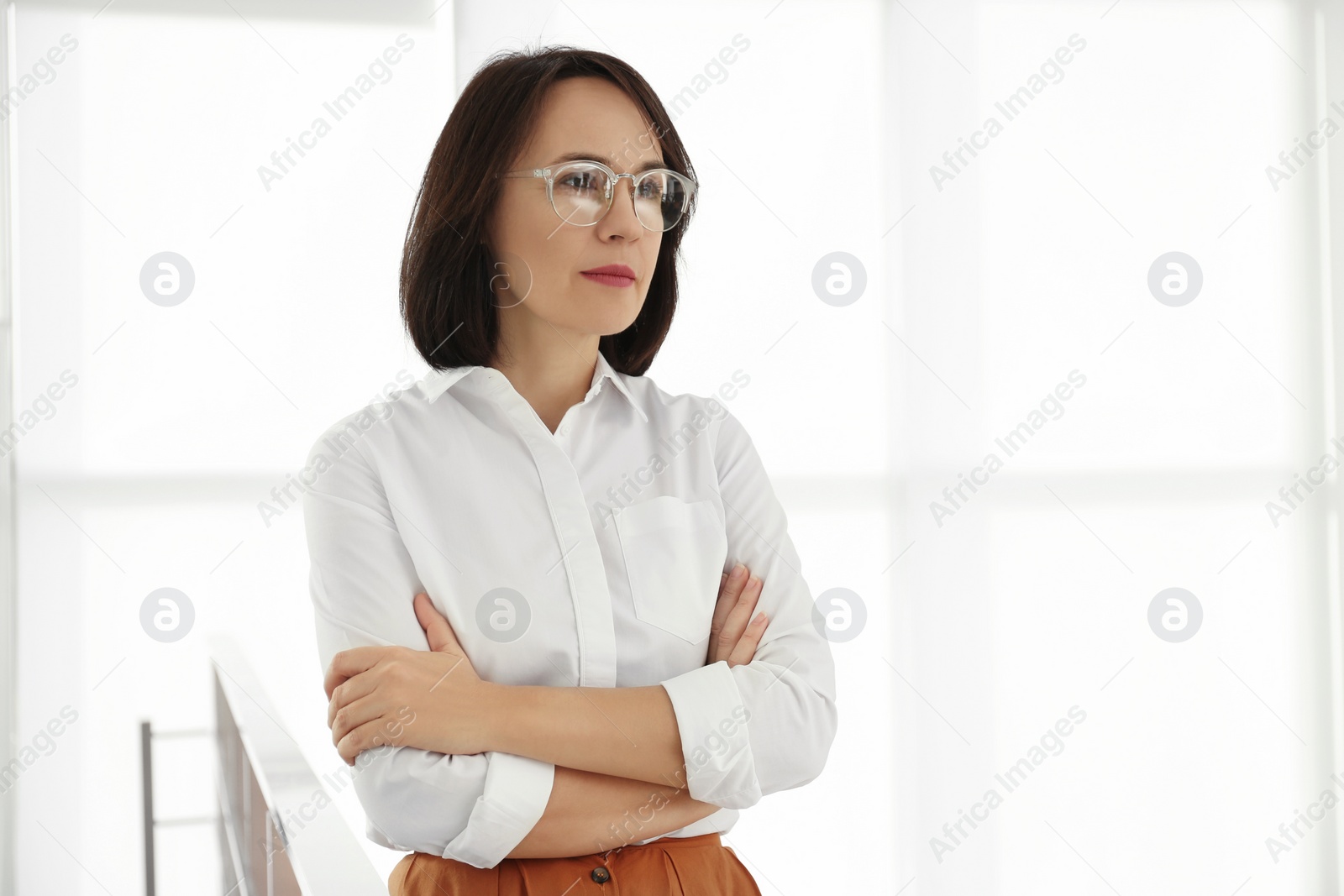 Photo of Mature businesswoman in office. Space for text