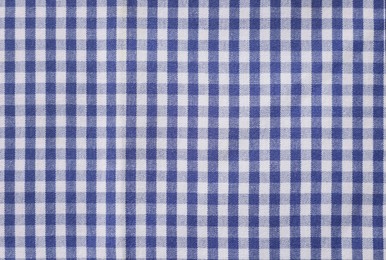 Blue checkered tablecloth as background, top view