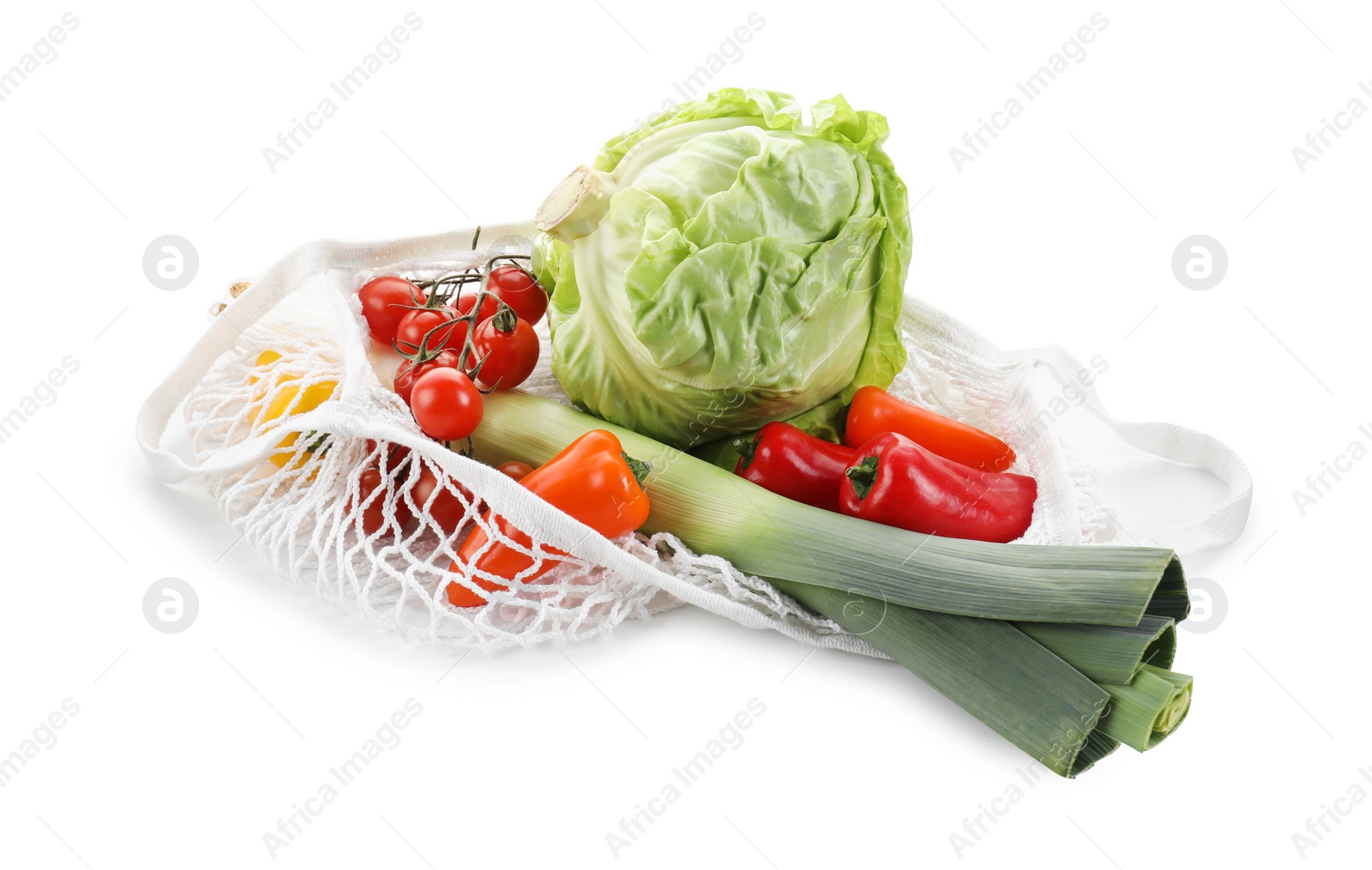 Photo of String bag with different vegetables isolated on white