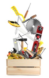 Image of Different carpenter's tools falling into wooden box on white background