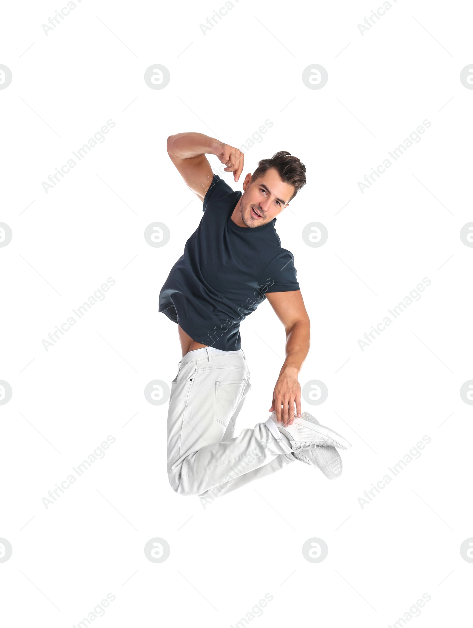 Photo of Young man in stylish jeans jumping on white background