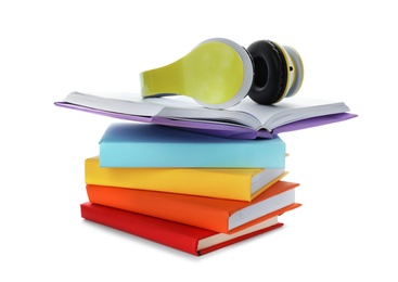 Photo of Modern headphones with hardcover books on white background