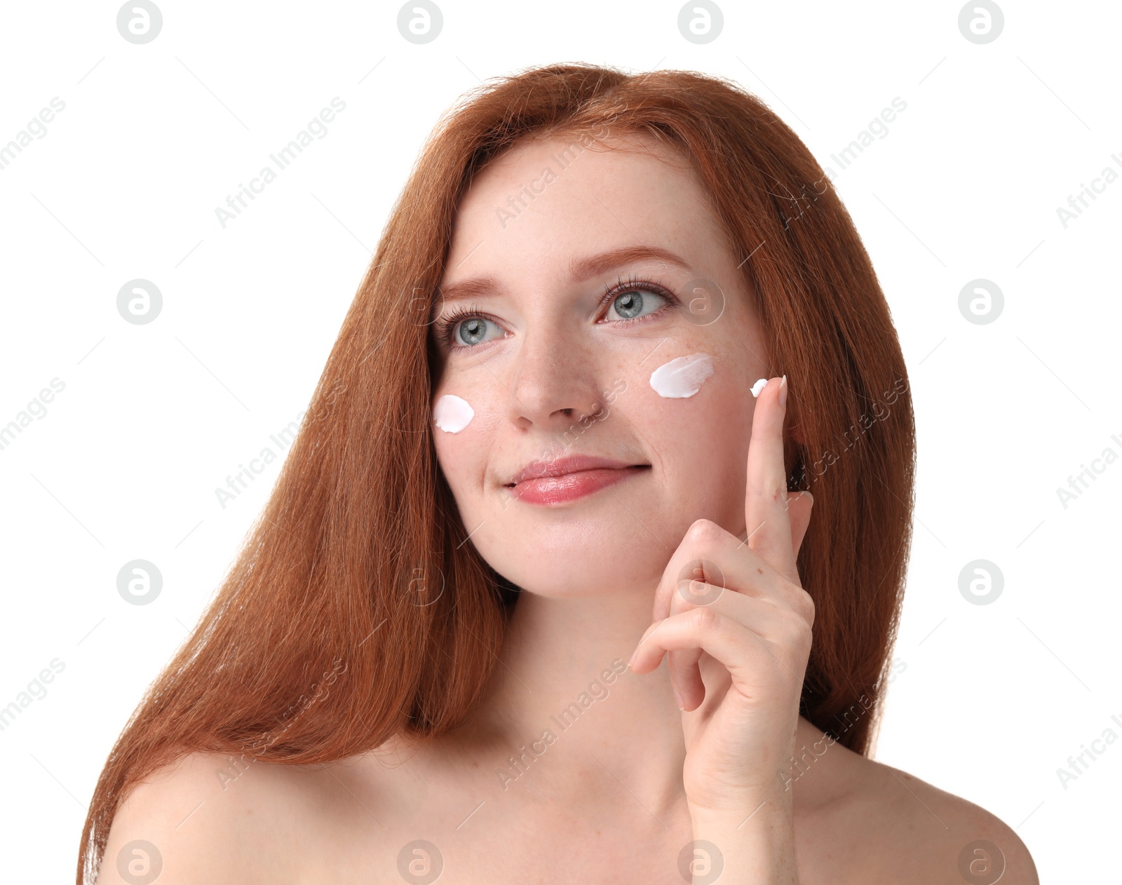 Photo of Beautiful woman with freckles and cream on her face against white background