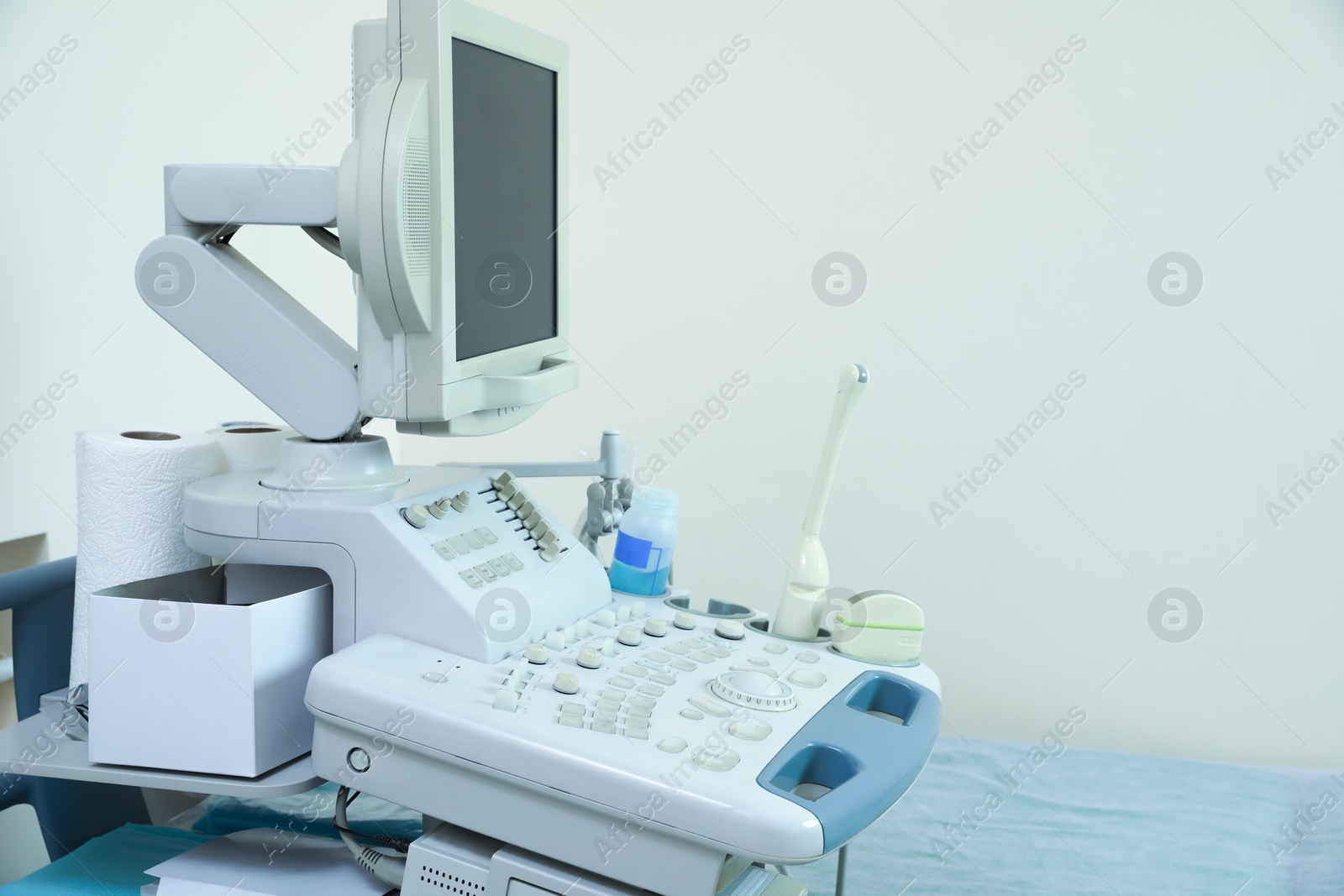 Photo of Ultrasound machine in hospital. Space for text