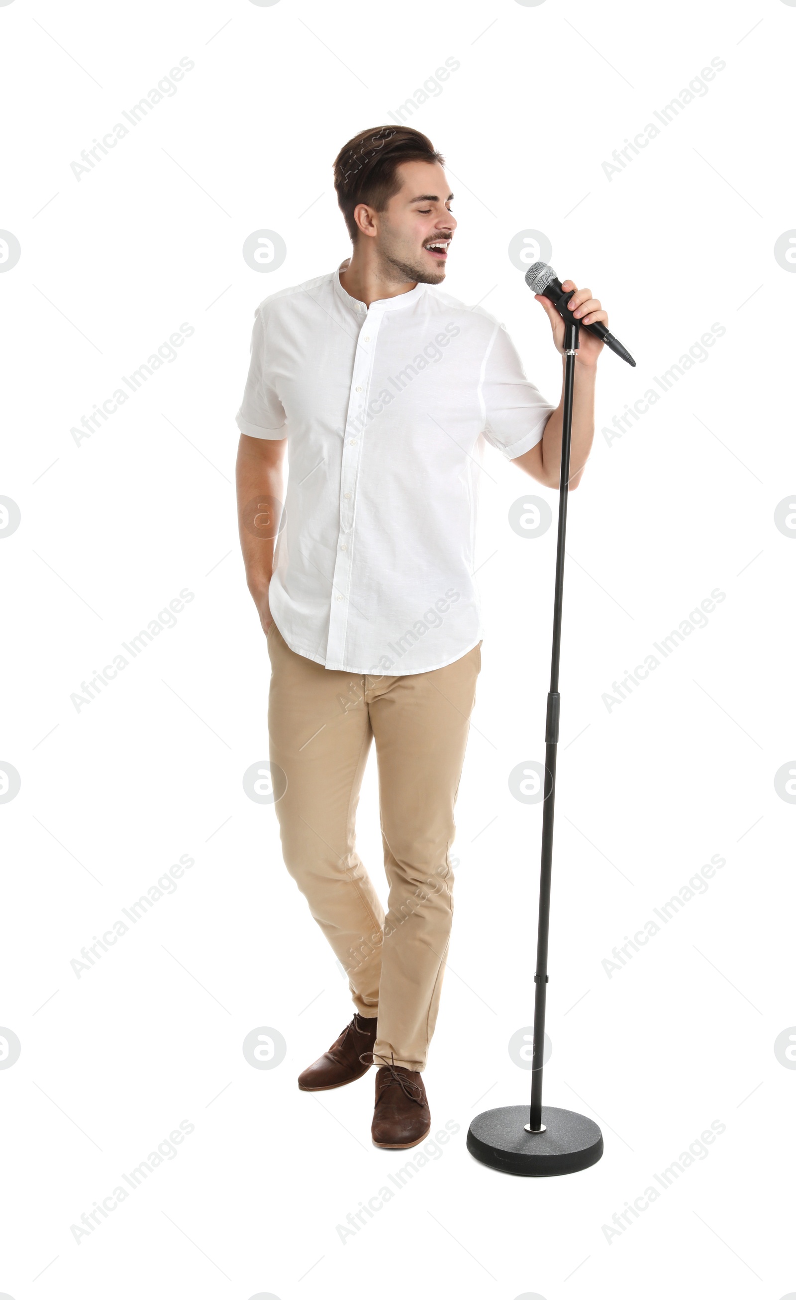 Photo of Young handsome man singing in microphone on white background