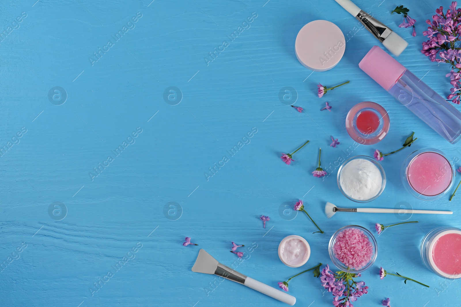 Photo of Flat lay composition with homemade cosmetic products and fresh ingredients on light blue wooden table. Space for text