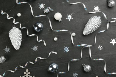 Photo of Flat lay composition with serpentine streamers and Christmas decor on black background