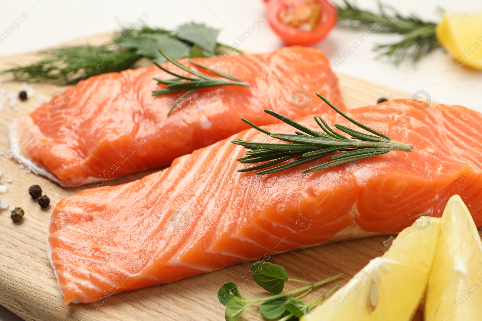 Photo of Fresh salmon and ingredients for marinade on wooden board, closeup