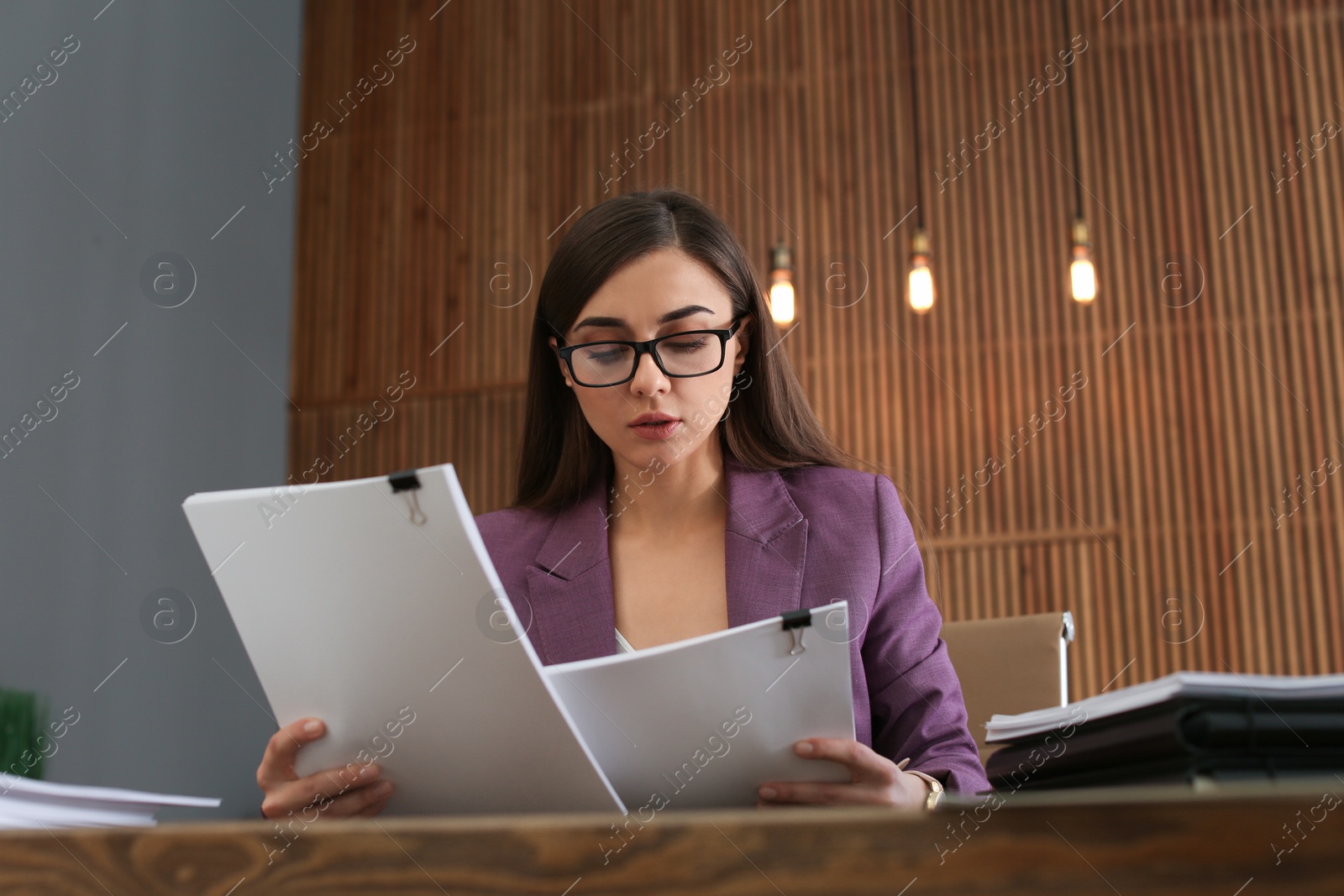 Photo of Beautiful businesswoman working with documents at table in office