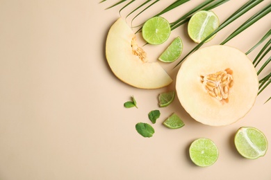 Photo of Flat lay composition with melon, lime and space for text on color background