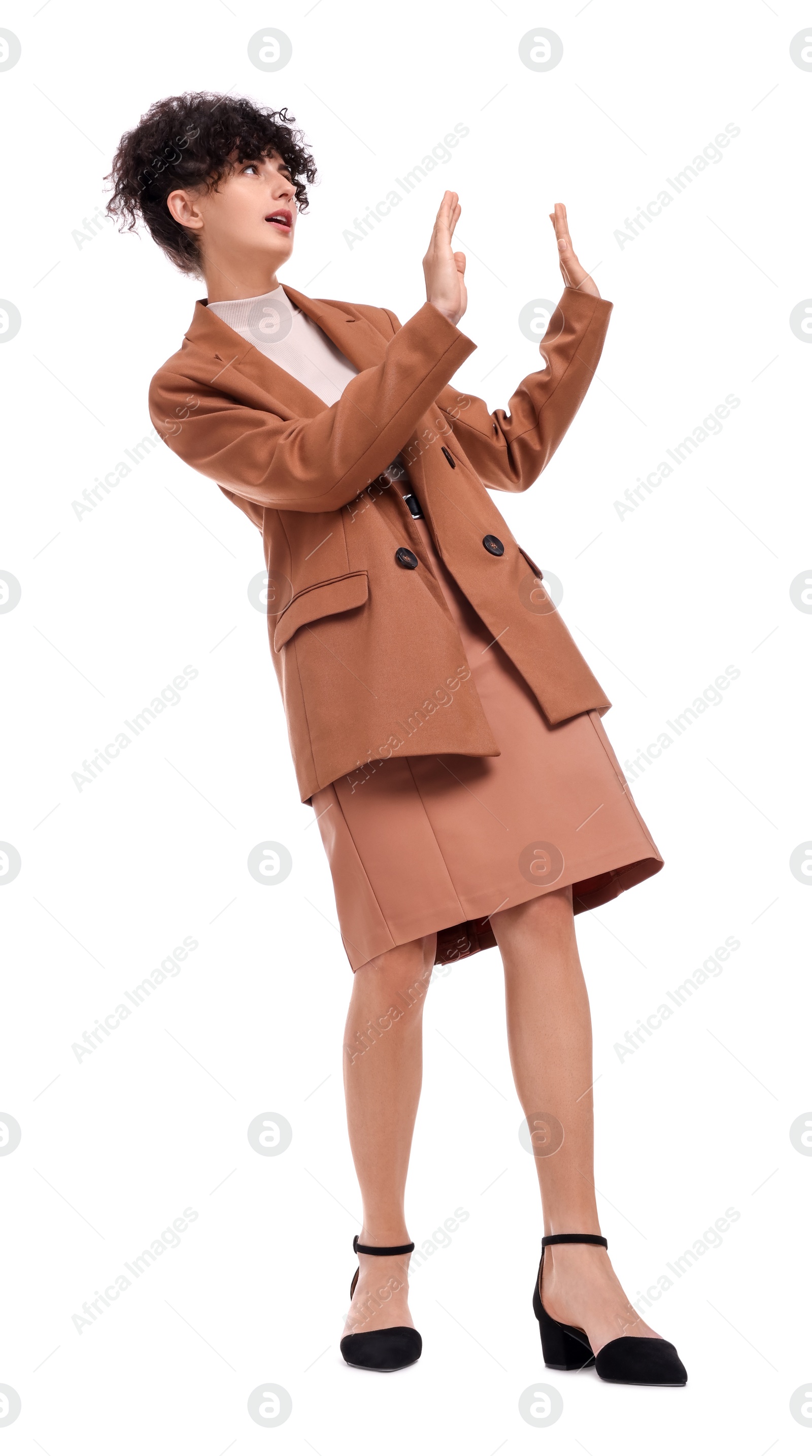 Photo of Beautiful businesswoman in suit avoiding something on white background