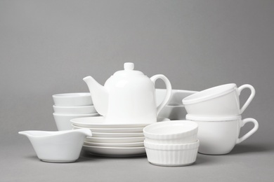 Set of clean tableware on grey background. Washing dishes