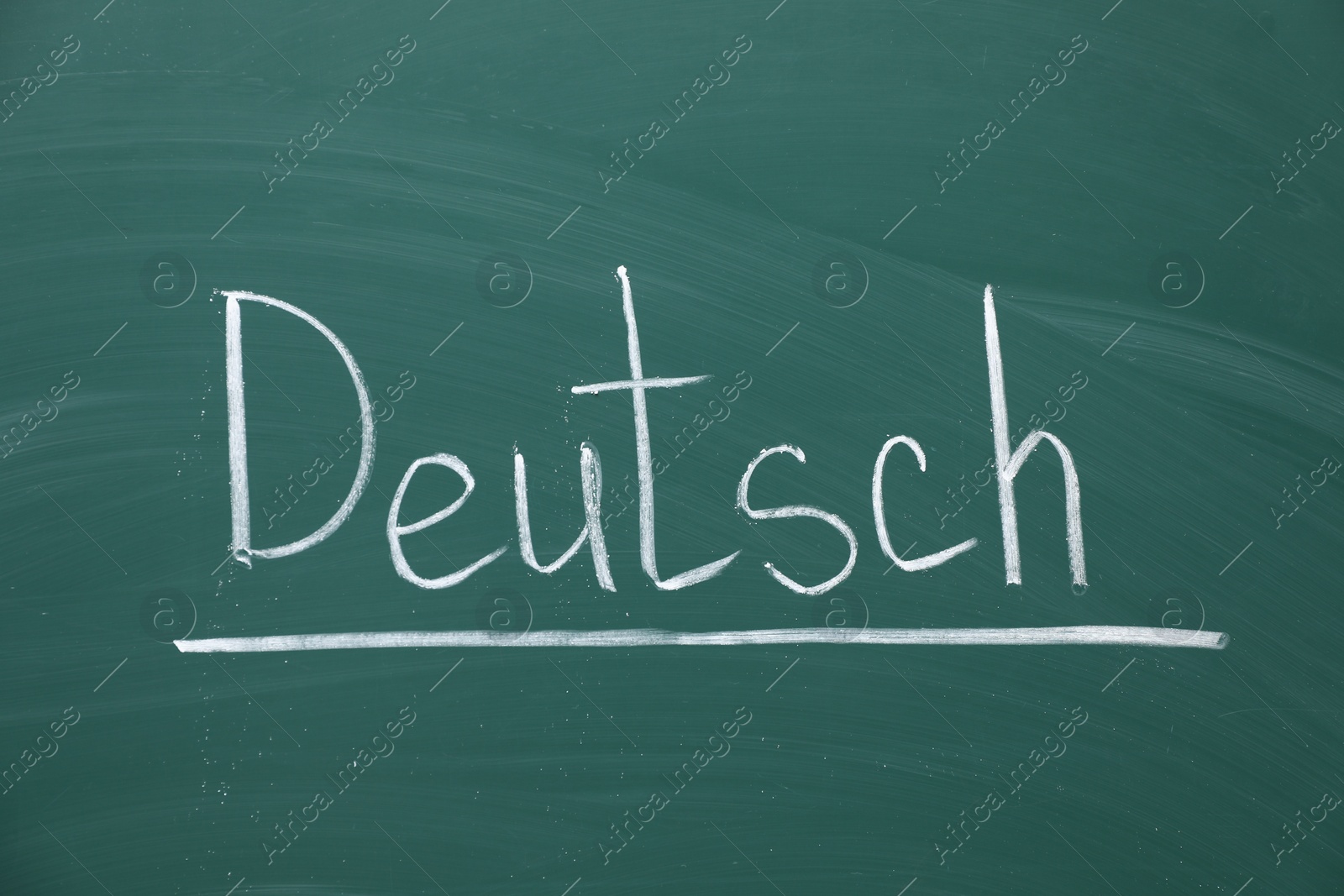 Photo of Word Deutsch written with chalk on green board