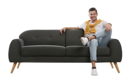 Man relaxing on comfortable grey sofa against white background