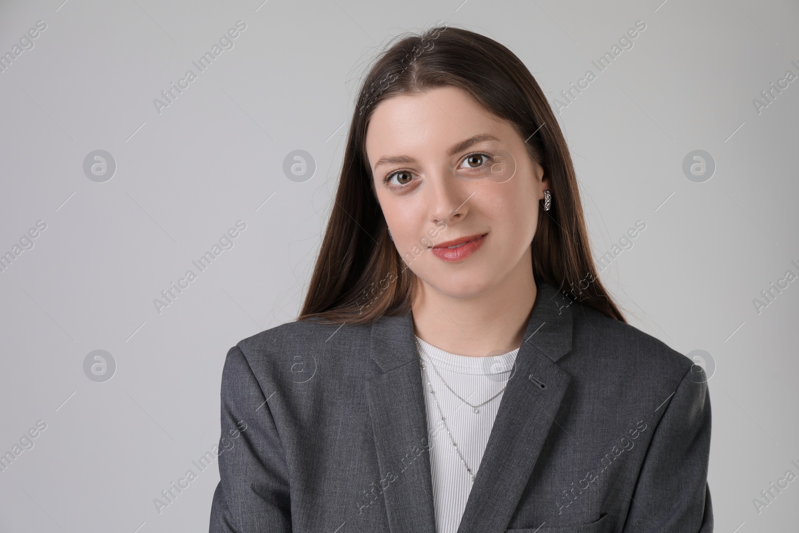 Photo of Portrait of beautiful young woman on light grey background