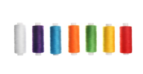 Photo of Set of colorful sewing threads on white background