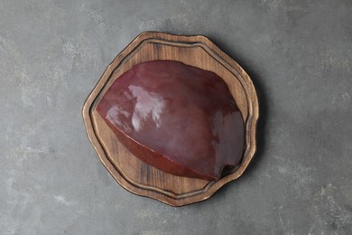 Piece of raw beef liver on grey table, top view